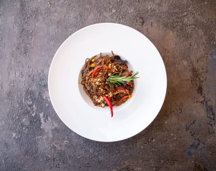 spaghetti pasta with red pepper and rosemary top view.