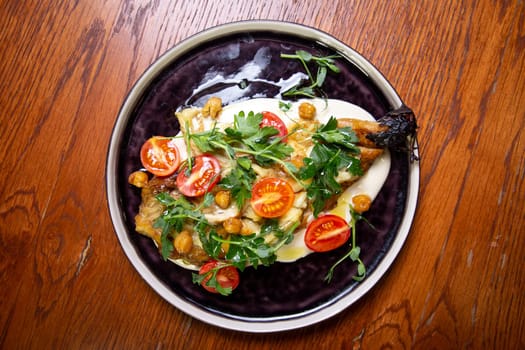 top view salad with cherry tomatoes, banana, chickpeas and herbs.