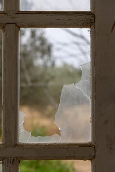 Glass broken by hooligans in a metal-plastic window, close-up. 3