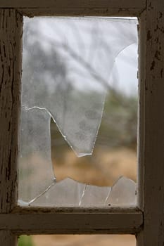 Glass broken by hooligans in a metal-plastic window, close-up. 2