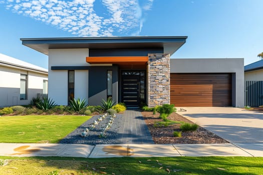 A modern house with a sprawling lawn and tall trees in the background.