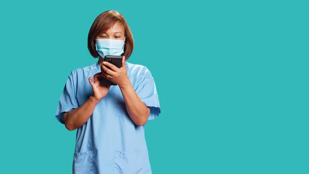 Worried nurse delivering bad news to patient in telemedicine phone chat. Clinic employee overthinking upsetting message for hospital visitor, isolated over blue studio background