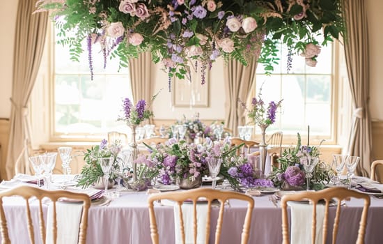 Wedding table decoration with lavender flowers, sweets, cake and candles