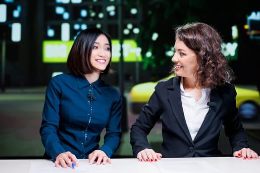 Reporters team on late night show in newsroom, presenting important topics information with exclusive details. Diverse journalists addressing celebrity gossip on tv live broadcast.