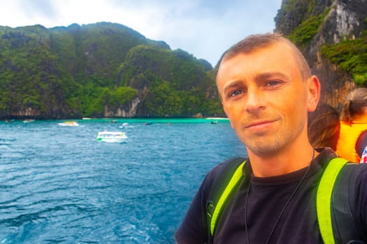 Man tourist on a ferry to Koh Phi Phi island in Ao Nang Amphoe Mueang Krabi Thailand in Southeast Asia.