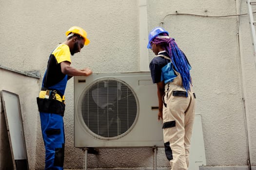 Certified engineers dismantling hvac system panel with industry techniques and equipment to repair refrigerant leaks, electrical system issues and frozen evaporator coils