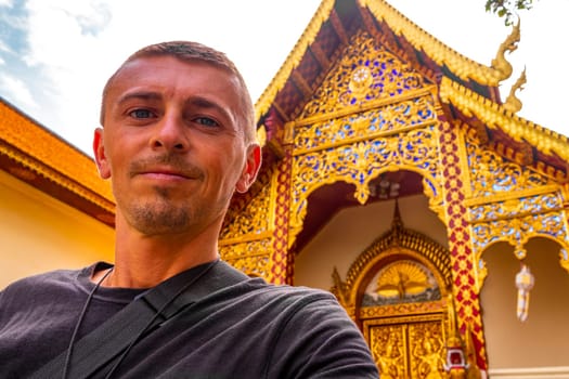 Handsome man male tourist at golden gold Wat Phra That Doi Suthep temple temples building in Chiang Mai Amphoe Mueang Chiang Mai Thailand in Southeastasia Asia.