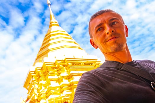 Handsome man male tourist at golden gold stupa pagoda Wat Phra That Doi Suthep temple temples building in Chiang Mai Amphoe Mueang Chiang Mai Thailand in Southeastasia Asia.