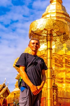 Handsome man male tourist at golden gold stupa pagoda Wat Phra That Doi Suthep temple temples building in Chiang Mai Amphoe Mueang Chiang Mai Thailand in Southeastasia Asia.