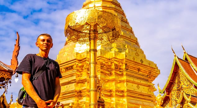Handsome man male tourist at golden gold stupa pagoda Wat Phra That Doi Suthep temple temples building in Chiang Mai Amphoe Mueang Chiang Mai Thailand in Southeastasia Asia.