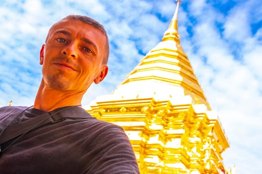 Handsome man male tourist at golden gold stupa pagoda Wat Phra That Doi Suthep temple temples building in Chiang Mai Amphoe Mueang Chiang Mai Thailand in Southeastasia Asia.