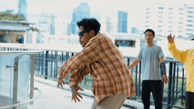 Hipster perform break dancing while partner dancing together at corridor, modern mall. Hip-hop music dancer practice footstep and move to music. Outdoor sport 2024. Active, energetic dance. Endeavor.