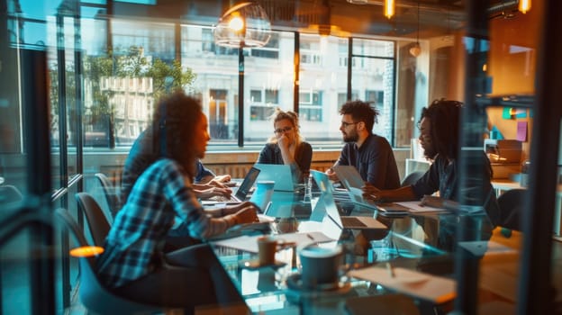 A group of creative people are sitting around a table with laptops in a group meeting business team AIG41