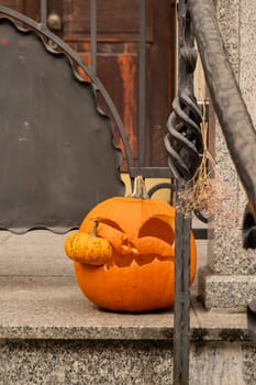 Halloween decorated outdoor cafe or restaurant terrace in America or Europe with carved pumpkins traditional attributes of Halloween. Frontyard decoration for party.
