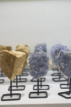 Various rocks are showcased on a table for art display.