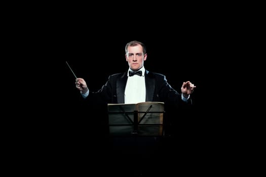 Studio photo of male music conductor holding his baton
