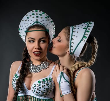 Portrait of two beautiful go-go dancers in sexy costumes