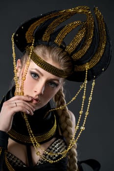 Studio portrait of beautiful go-go dancer in headdress