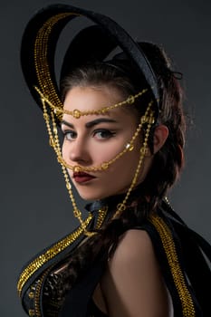 Studio portrait of pretty dancer in headdress with beads