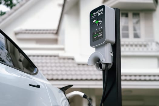 Electric vehicle technology utilized to residential area or home charging station for EV car battery recharge. Eco-friendly transport by clean and sustainable energy for future environment. Synchronos
