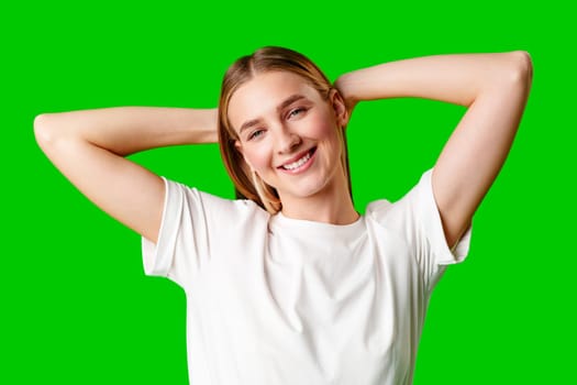 Young Woman in White Shirt Posing for Picture against green background in studio