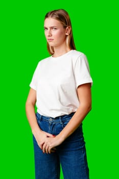 Young Woman With Pursed Lips Expressing Skepticism Against Green Screen Background in studio