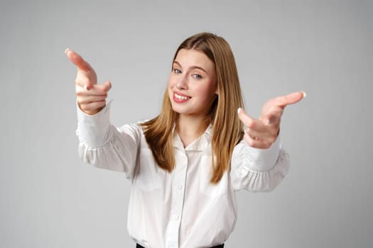 Young Woman in White Shirt Gesturing Come Here With Both Hands Indoors