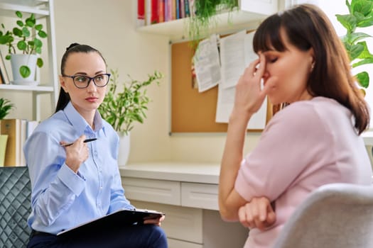 Professional mental psychologist counselor at therapy session with female patient. Talking women sitting in office, psychology, psychotherapy, counseling, health care, support help treatment concept