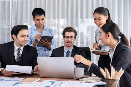 Diverse of business people from various ethnic group working in modern office environment. Productive and multi ethnic office workers engage in discussion for strategic business marketing. Meticulous