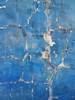 The blue backdrop is a web of abstract cracks, a striking visual of deterioration and the beauty found within it