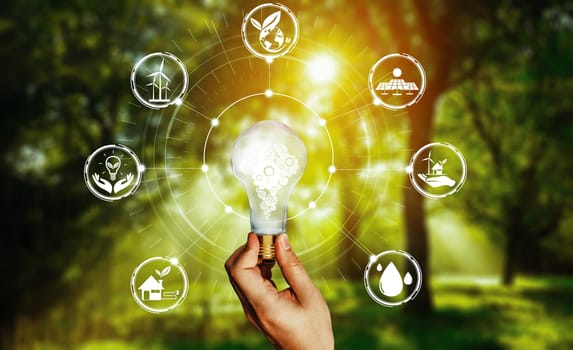 Green energy innovation light bulb with future industry of power generation icon graphic interface. Concept of sustainability development by alternative energy. uds