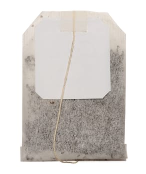 Disposable tea bag with paper label on a string on isolated background