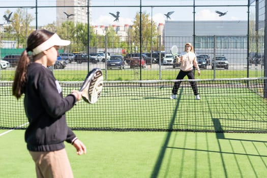 mother and daughter play padel. High quality photo