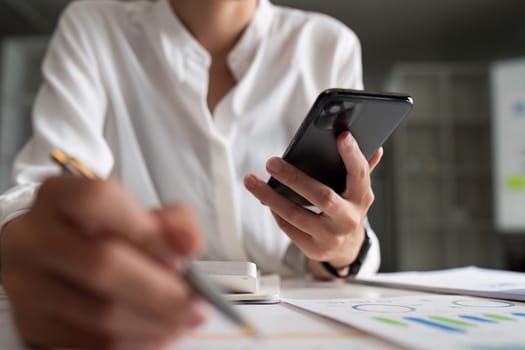 Typing, hand and person with a phone in an office for a search, online chat or email on a website. Communication, closeup and an employee with a mobile.