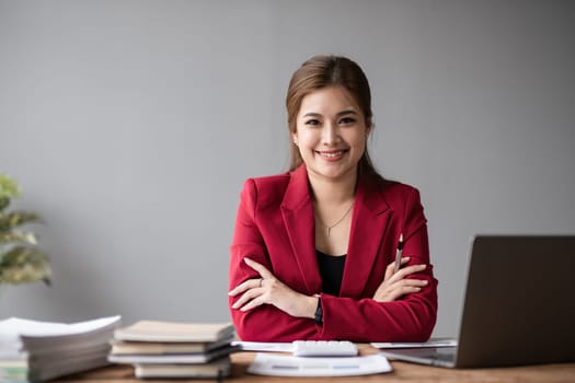 Portrait of a confident Asian business woman Working in a modern office desk using a laptop computer marketing concept.