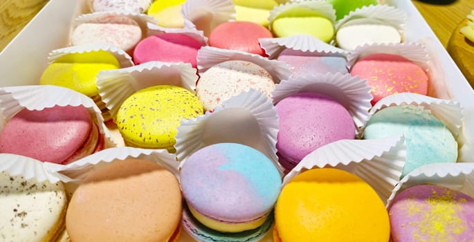 colorful macarons lie in a box, feast