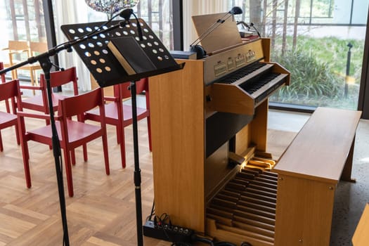 Small indoors pipe organ. Musical instrument for church singing and concerts.