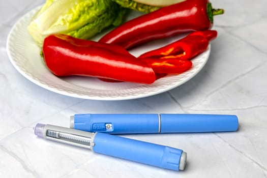 Original Danish Ozempic Insulin injection pen for diabetics and plate with vegetables. High quality photo