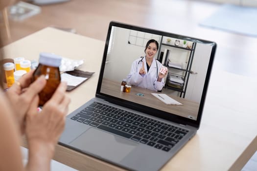 Elderly woman sit at home having online consultation with doctor on computer laptop, sick senior talk on video call consulting with nurse using laptop, healthcare concept.