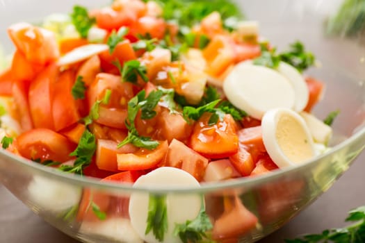 fresh vegetable salad, cabbage, tomatoes in a bowl on a wooden table .