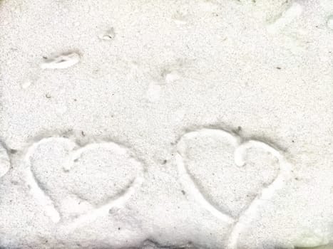 Heart on snow. Hearts traced on white blanket of snow. Background, texture. Valentine's day