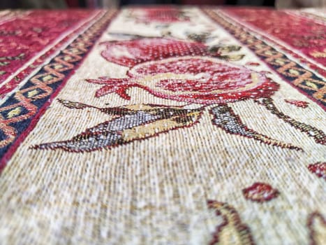 A tablecloth on the table or a carpet on the floor. Background, texture. Detailed texture of a patterned fabric surface