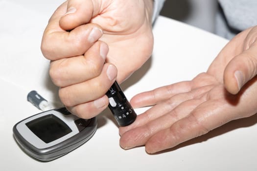 Diabetic man measuring blood sugar level. Blood test for diabetes. High quality photo
