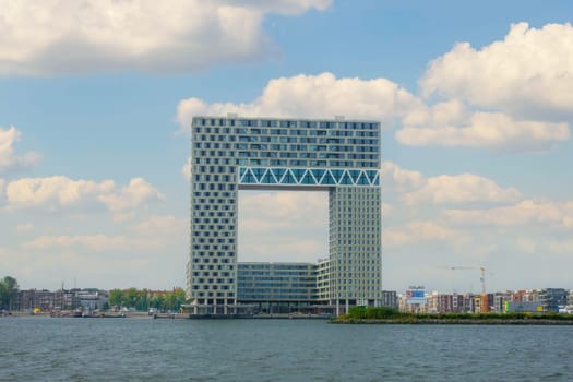 Netherlands. Summer day in Amsterdam. Modern office building on the shore of the Amstel river