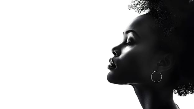 A monochrome photo capturing a happy woman with hoop earrings, showcasing her eyelashes and jawline. The flash photography highlights her elegant gesture and stylish eyewear