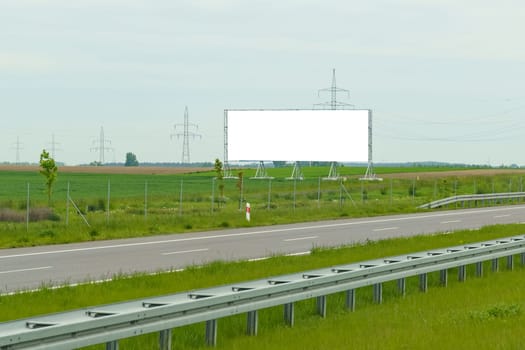 Large billboard promoting a product or service on the side of a bustling highway, attracting the attention of passing motorists.