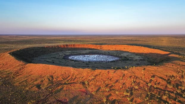 Drone photo at sunset above the second largest rimmed meteor impact crater in the world, based in remote Western Australia,