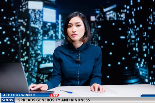 News about lottery winner generosity and kindness, lucky person donating part of prize addressed by asian media reporter. Woman newscaster hosting live night show on tv channel.