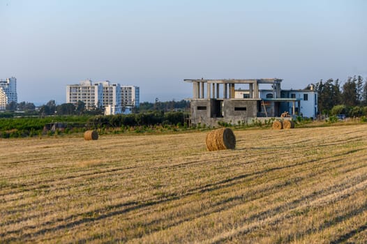 Straw bales on farmland with blue cloudy sky 2