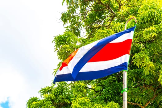 Costa Rican flag with blue sky background in Alajuela Costa Rica in Central America.